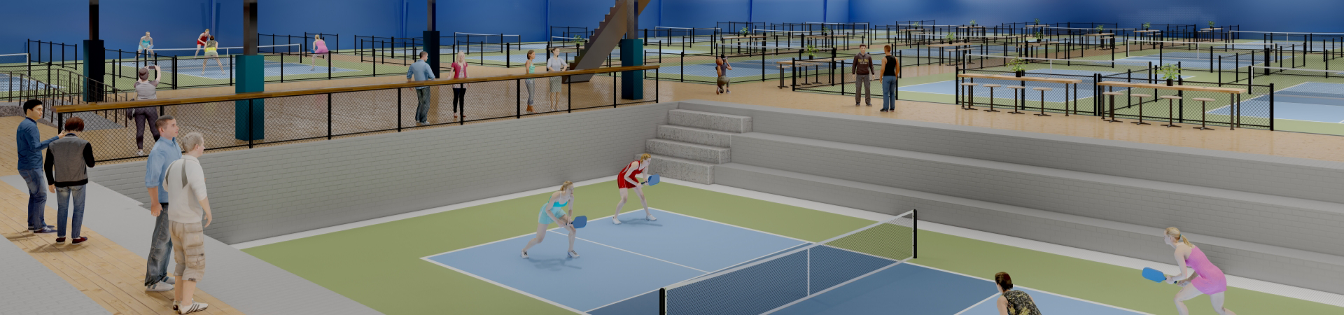 People enjoy a lively pickleball game on a court within a bustling indoor pickleball center, which boasts multiple courts for players and spectators alike.